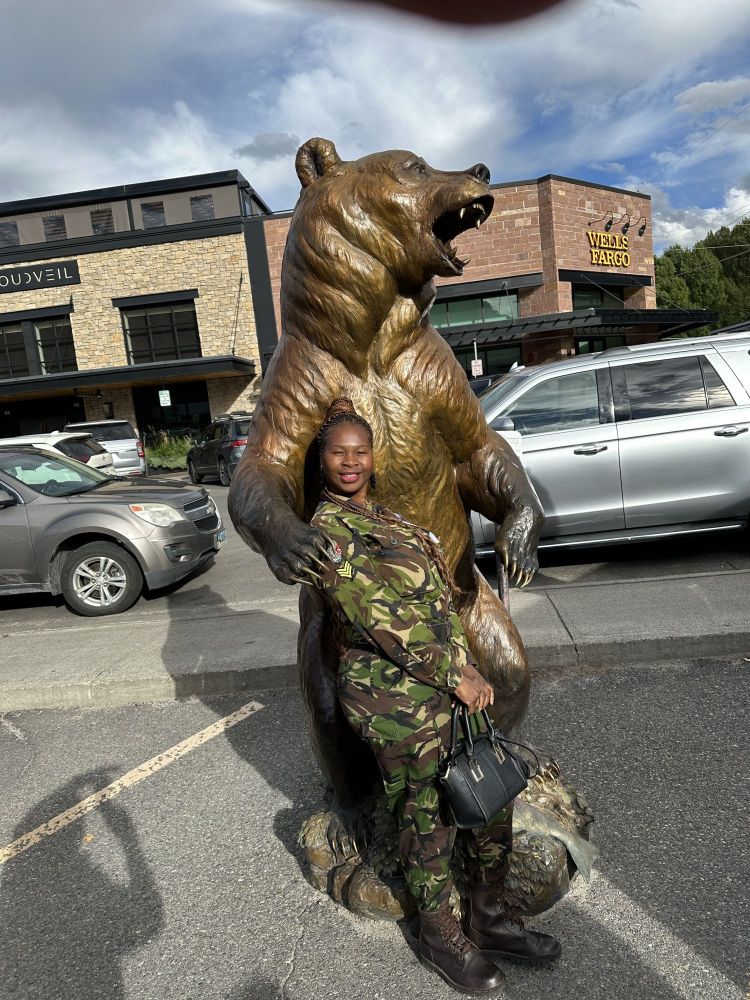leitah with the black mamba's, posing in front of Mountain Trail's gallery