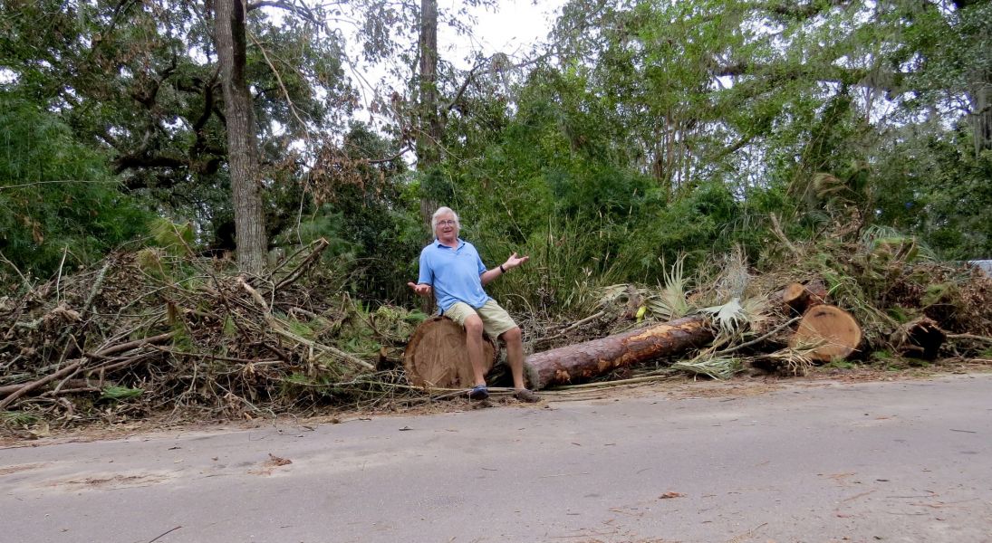  Jim sitting on one of the smaller piles of debris in front of our house- unfortunately all our photographs of the hurricane are from the iPhone which I can't copy here