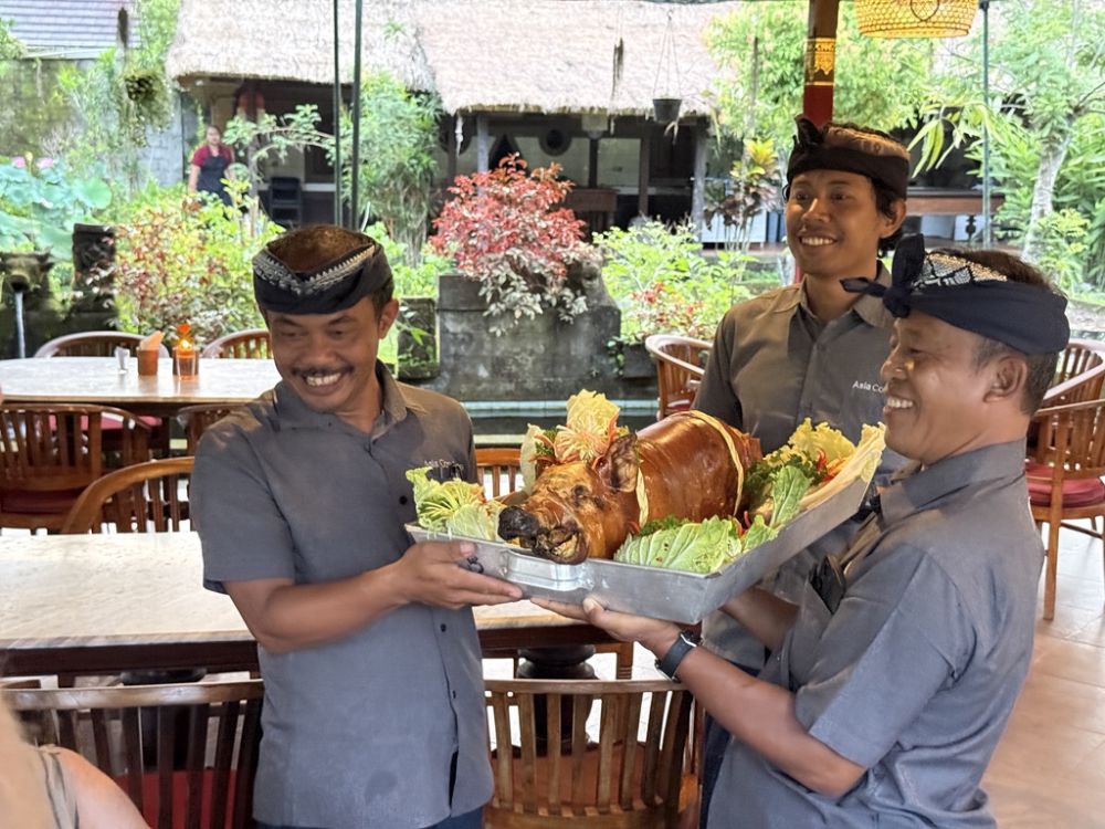 Sharing a roast pig with our guides and friends was a wonderful sendoff to an incredible visit