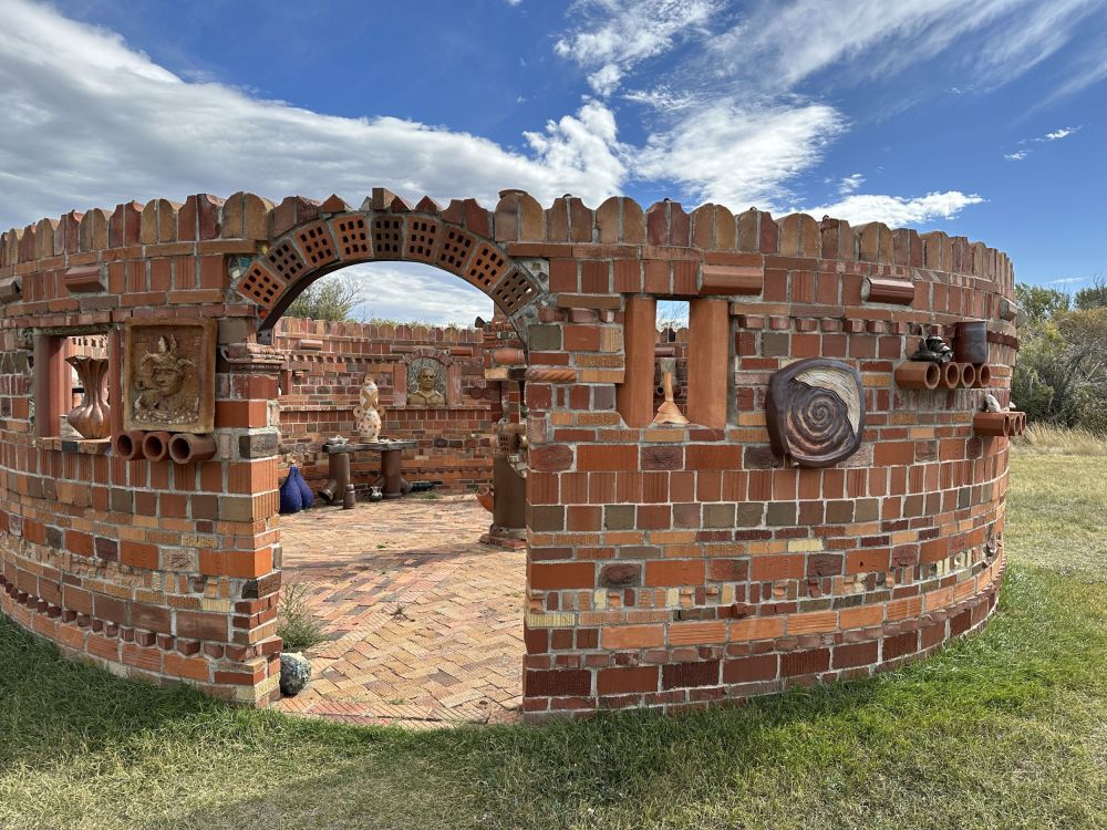 This is a beautiful art piece made from old bricks and inset with lots of ceramic art