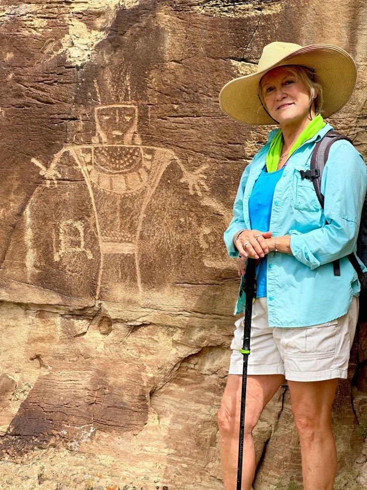 Is this a modern artist standing next to a depiction of an early Indian artist?