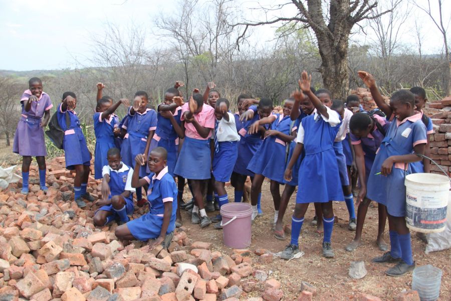  These girls are breaking rocks to cover their schoolyard